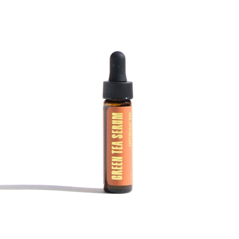 Bottle of green tea serum on a white background