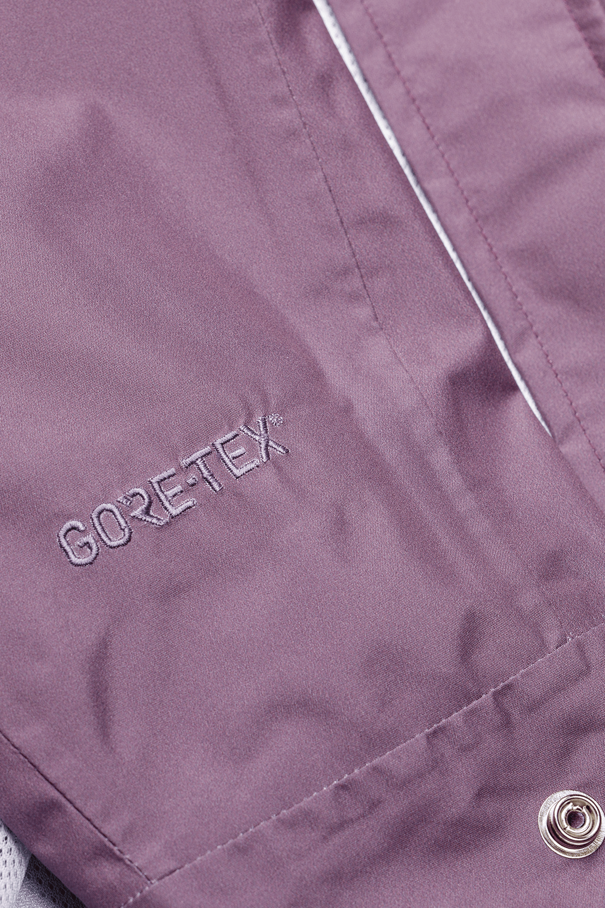 Close-up of a purple fabric with GORE-TEX branding.
