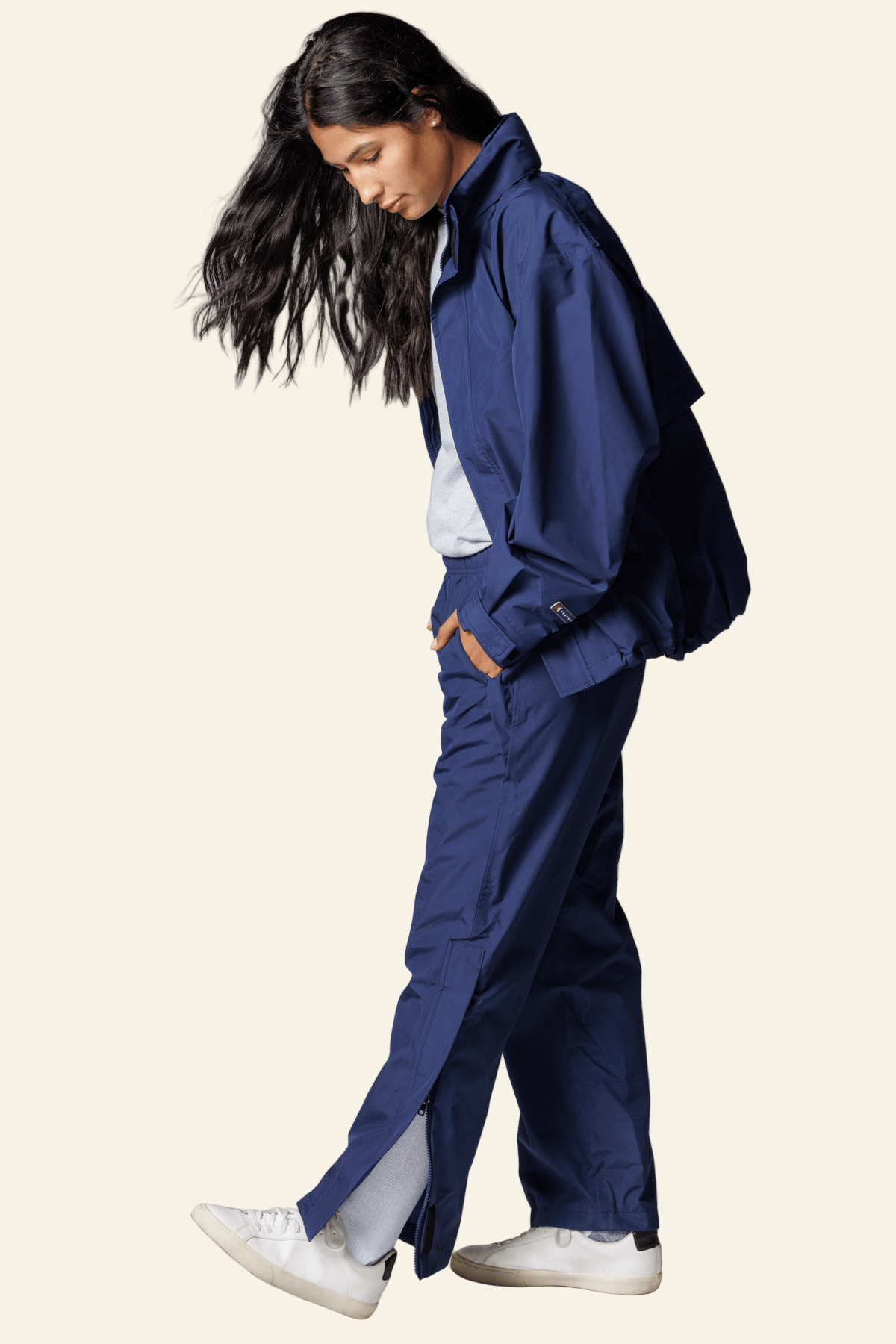 Person wearing a blue tracksuit on a white background