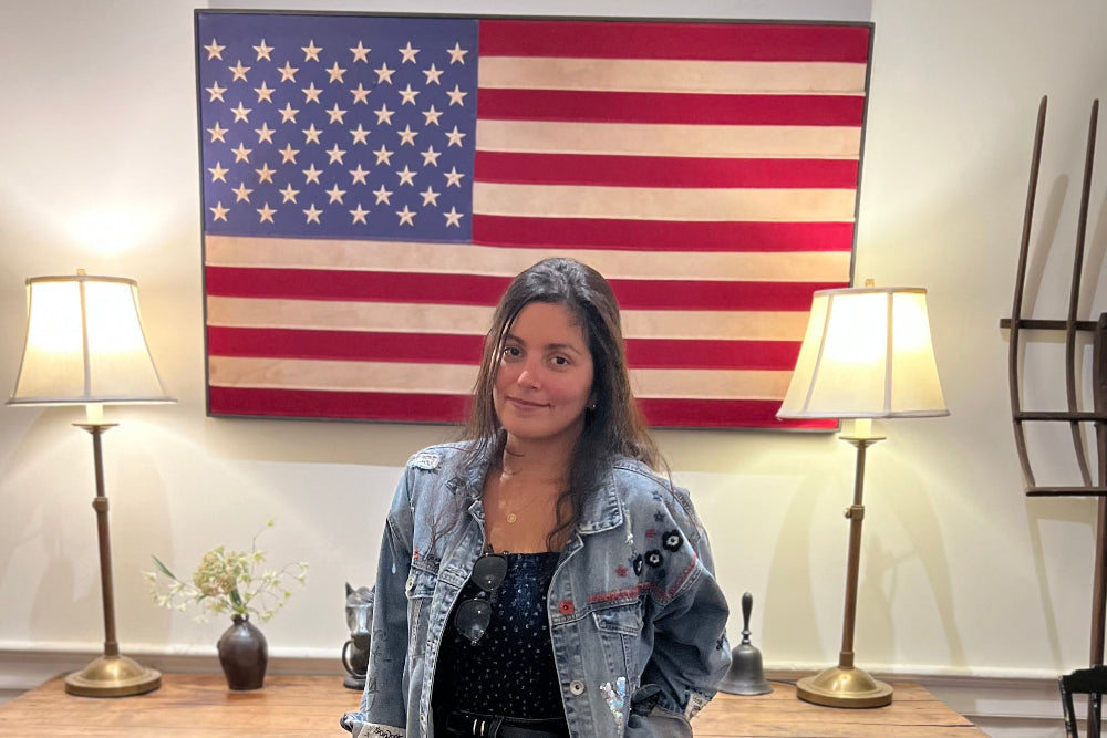 My American Goods founder workspace with American-made theme, laptop logo, notebook, and USA flag symbolizing the revival of American-made products”