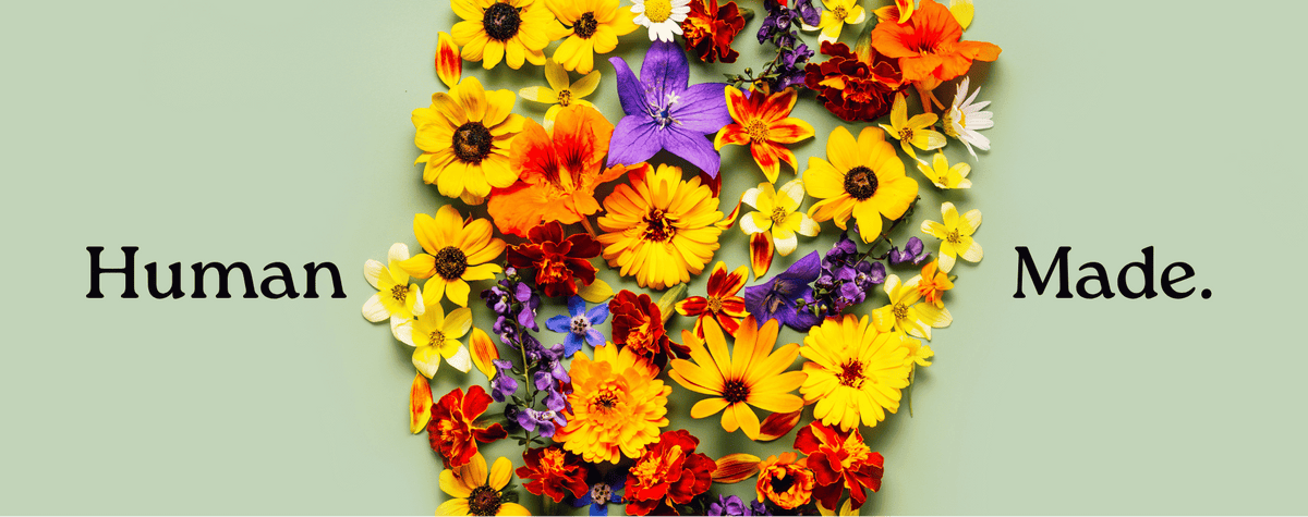 Flowers manually arranged and the words Human - Made