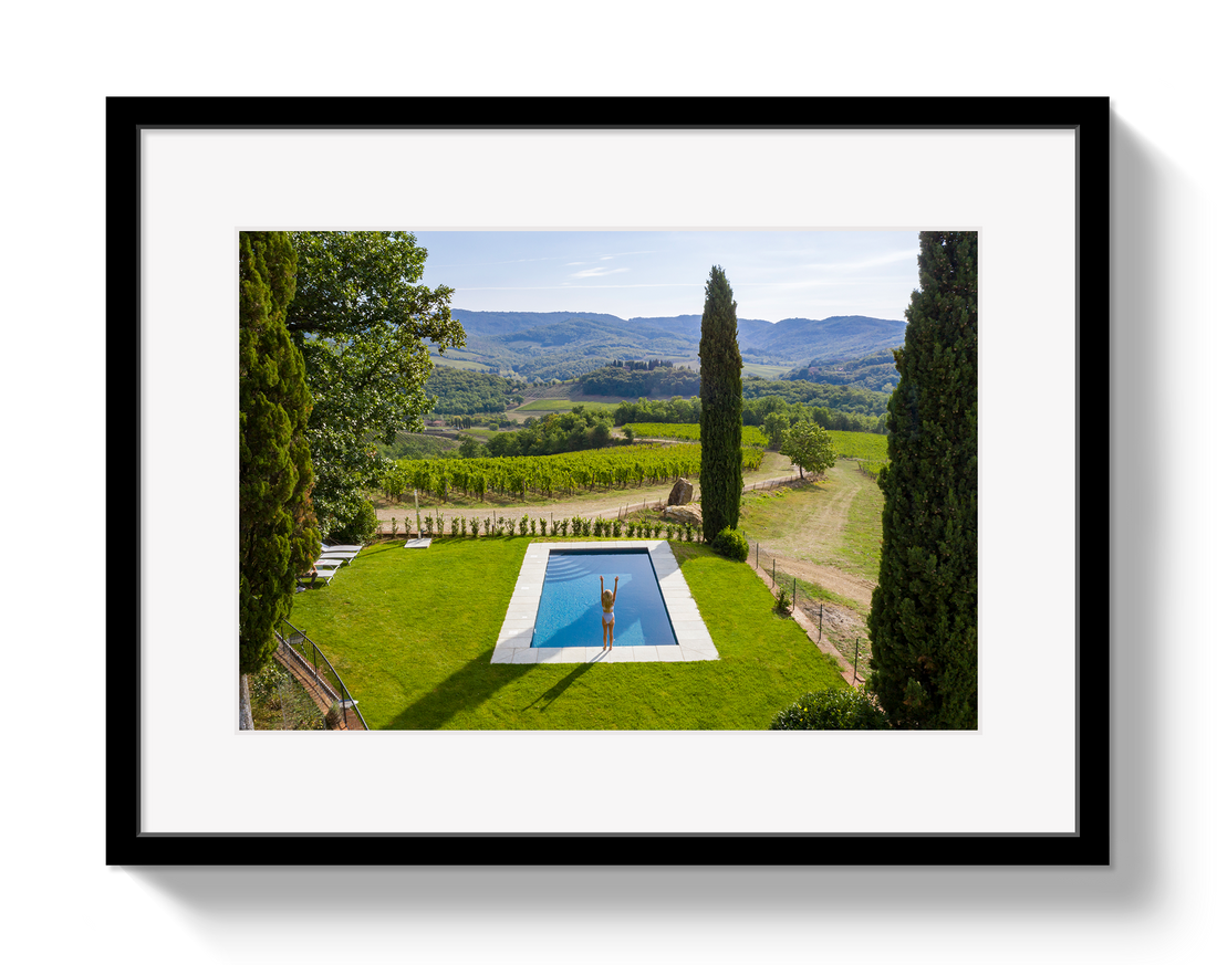 Framed photograph of a pool with a scenic landscape in the background
