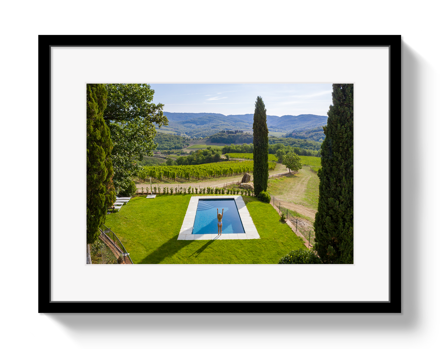Framed photograph of a pool with a scenic landscape in the background