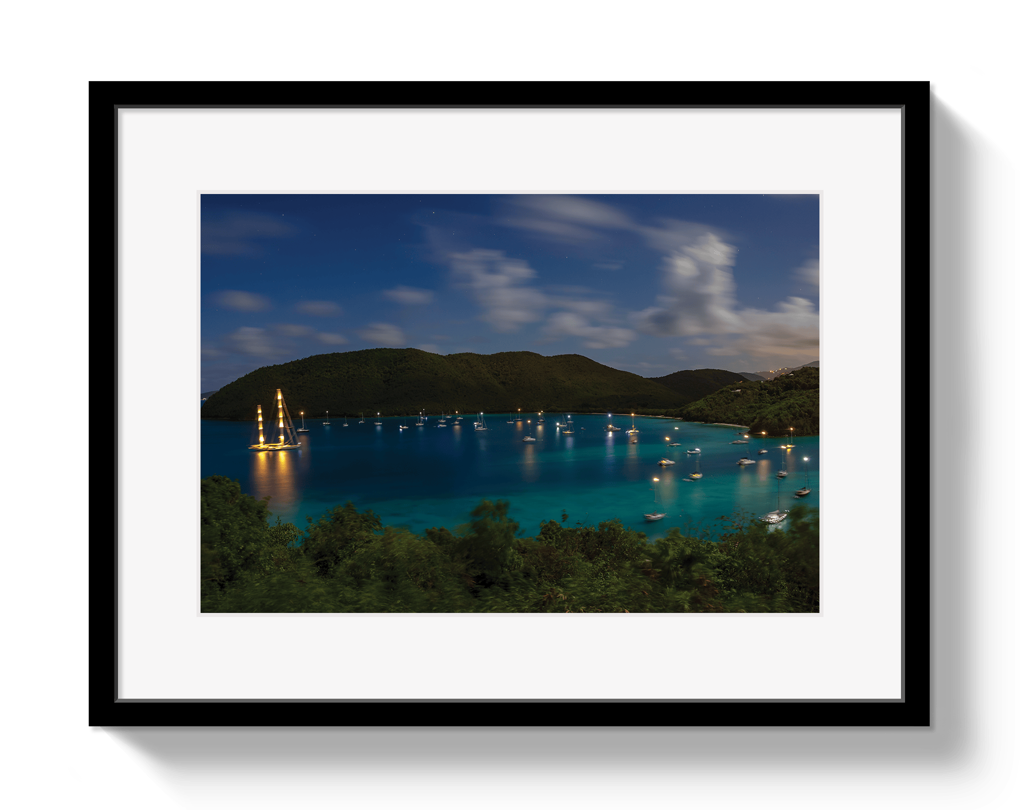 Framed photograph of a nighttime scene over a body of water with lights.