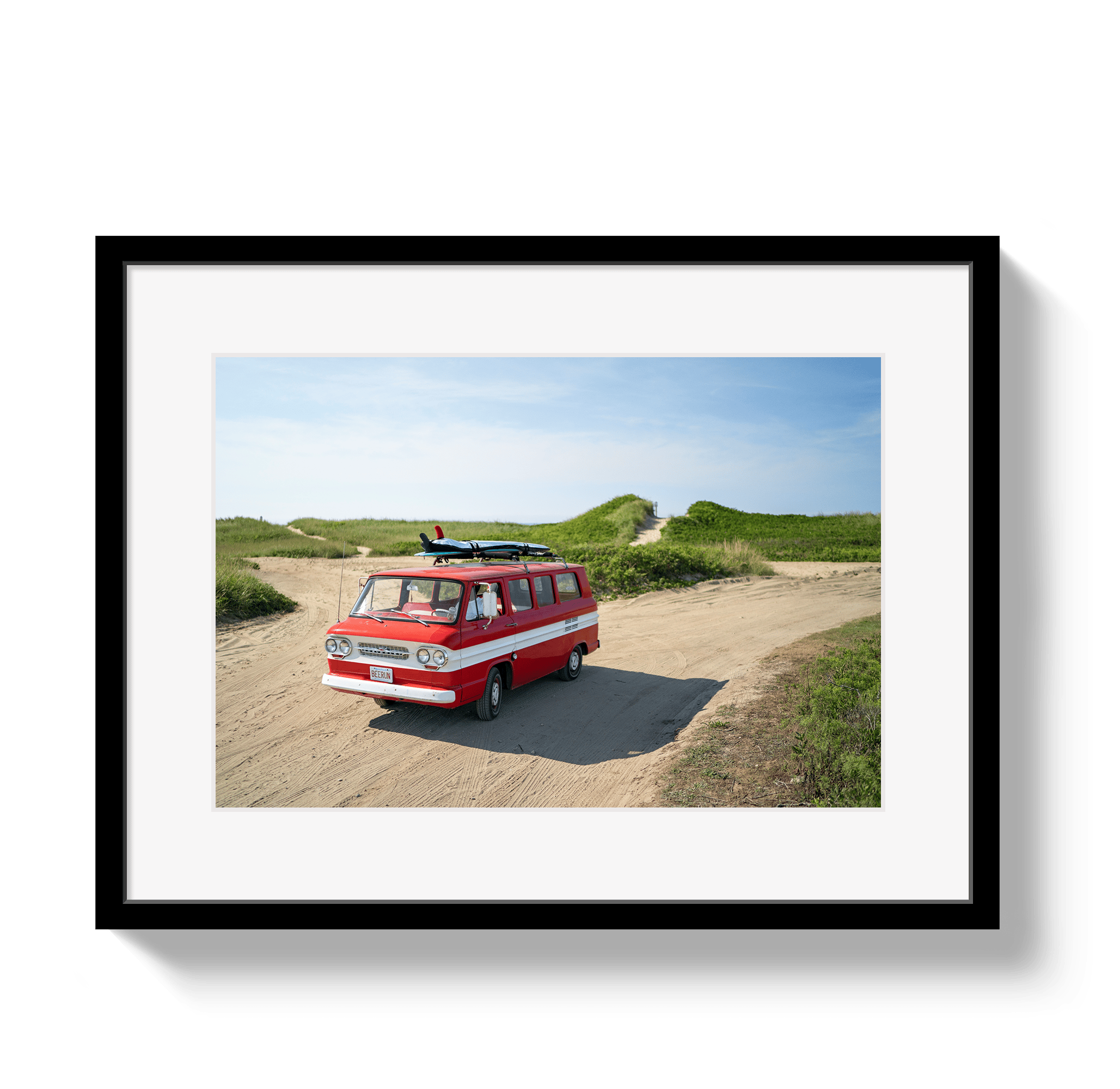 Framed photograph of a red van with a surfboard on a beach path