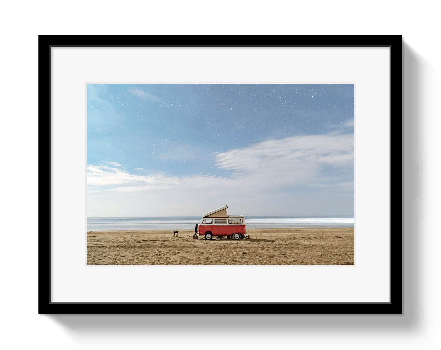 Framed photograph of a red van with a surfboard on a beach