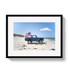 Framed photo of a blue truck with an American flag on a beach