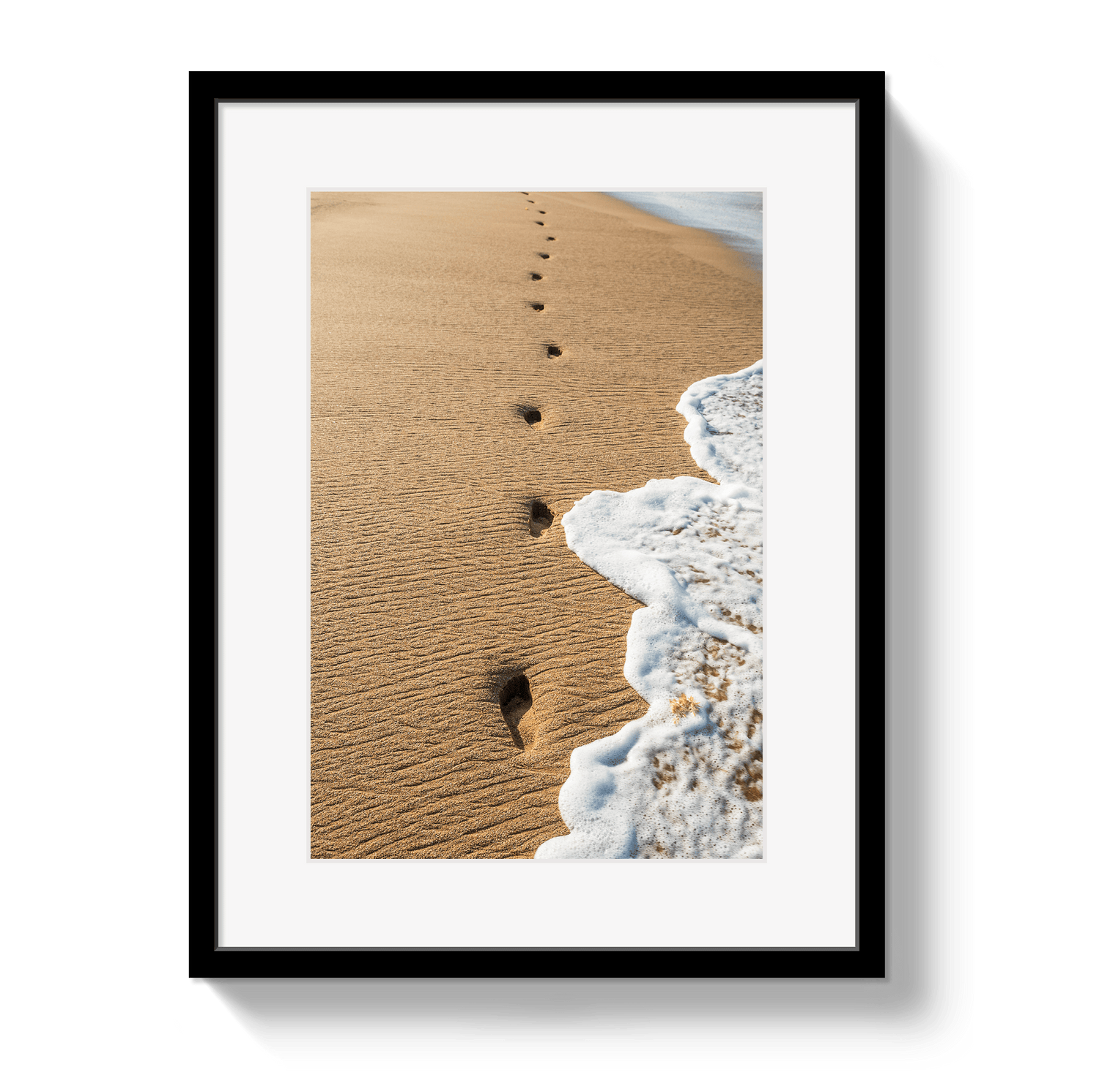 Framed artwork of footprints in sand leading to the sea