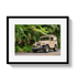 Framed photograph of a vintage SUV on a road with greenery in the background