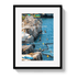 Framed photograph of people diving into a blue body of water from a rocky cliff.