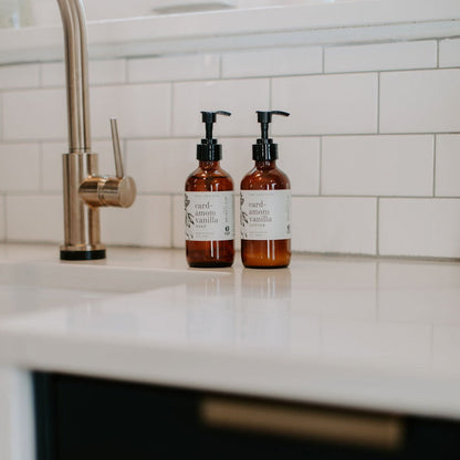 Two brown bottles with pump dispensers on a kitchen counter.