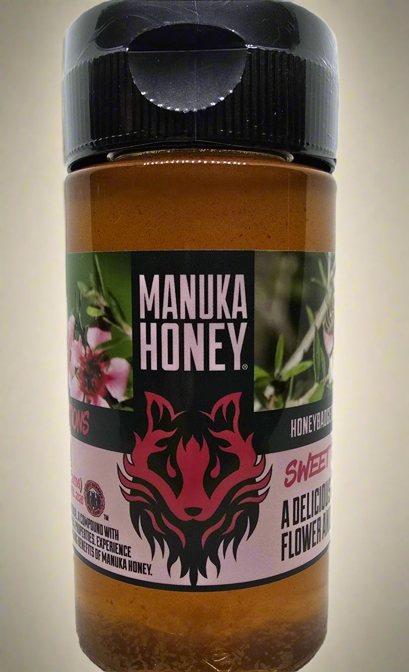 Manuka Honey jar with black lid on a white background