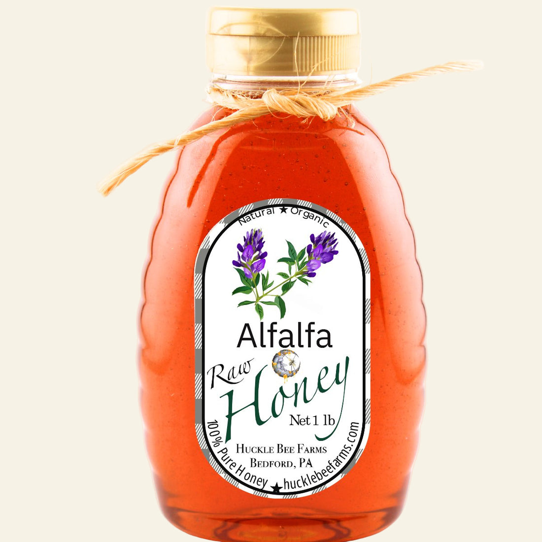 Bottle of alfalfa honey with a label on a white background