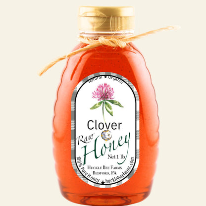 Bottle of clover honey with a label on a white background