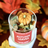 Candle in a glass jar labeled &