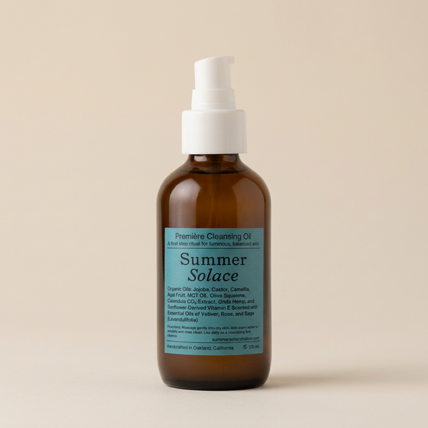 An amber glass bottle of Summer Solace cleansing oil with a white pump dispenser and a light blue label, set against a solid beige background.