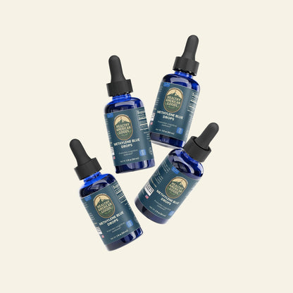 Four bottles of Healthy Earth Labs Neem Blue Drops on a white background