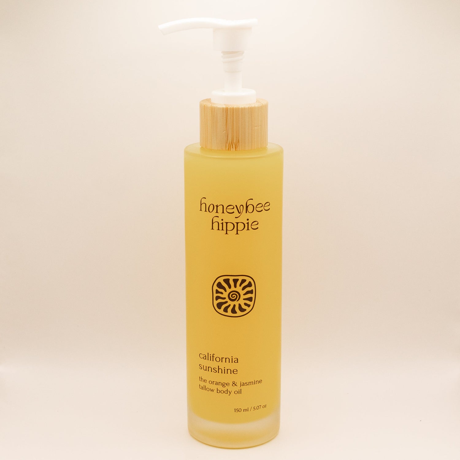 Yellow bottle of honeybee hippie California Sunshine body oil on a beige background