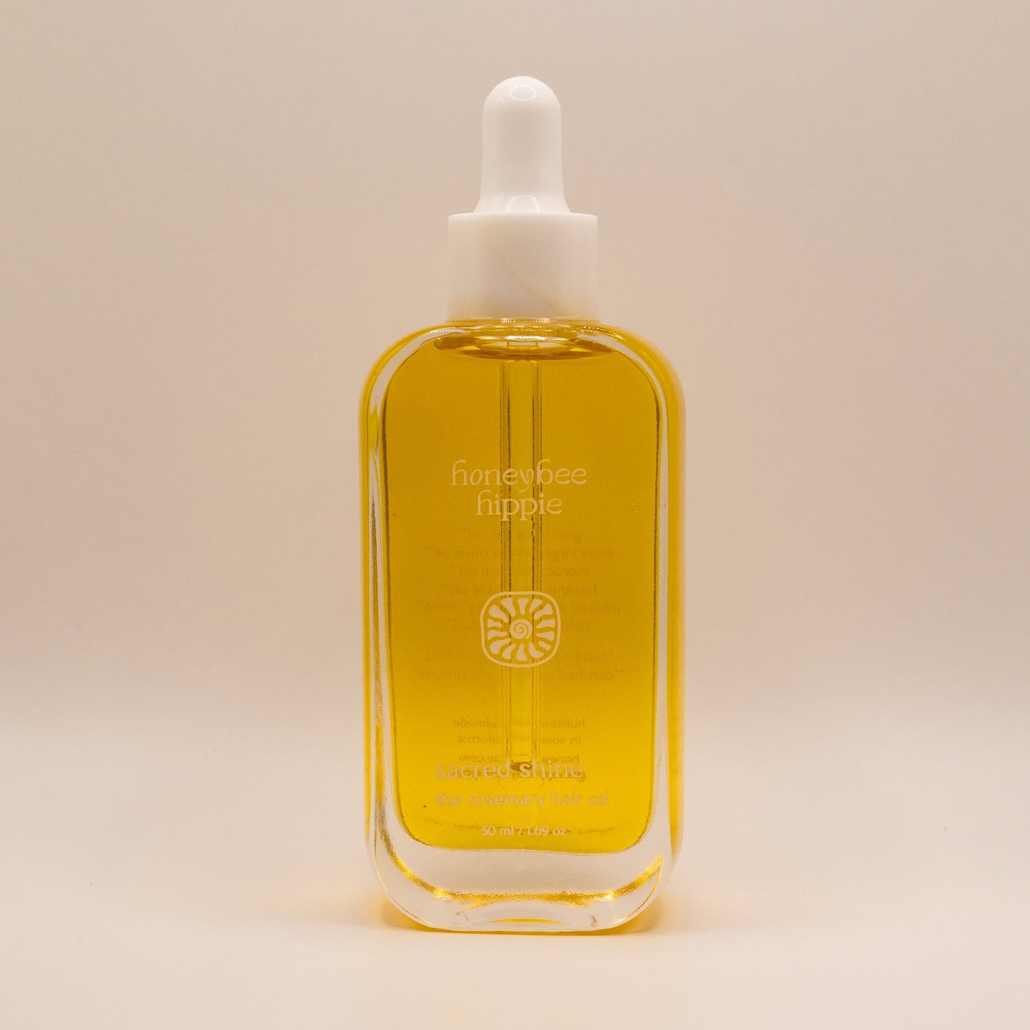 Bottle of honeybee hippie product on a beige background