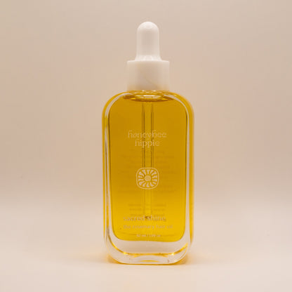 Bottle of honeybee hippie product on a beige background