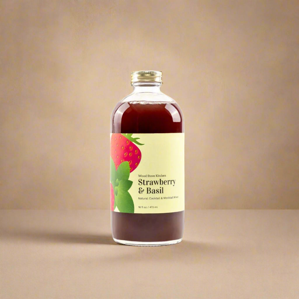 Bottle of strawberry and basil-flavored liquid on a white background