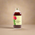 Bottle of strawberry and basil-flavored liquid on a white background