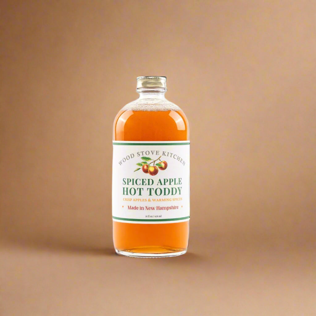 Bottle of spiced apple hot toddy with a label on a white background