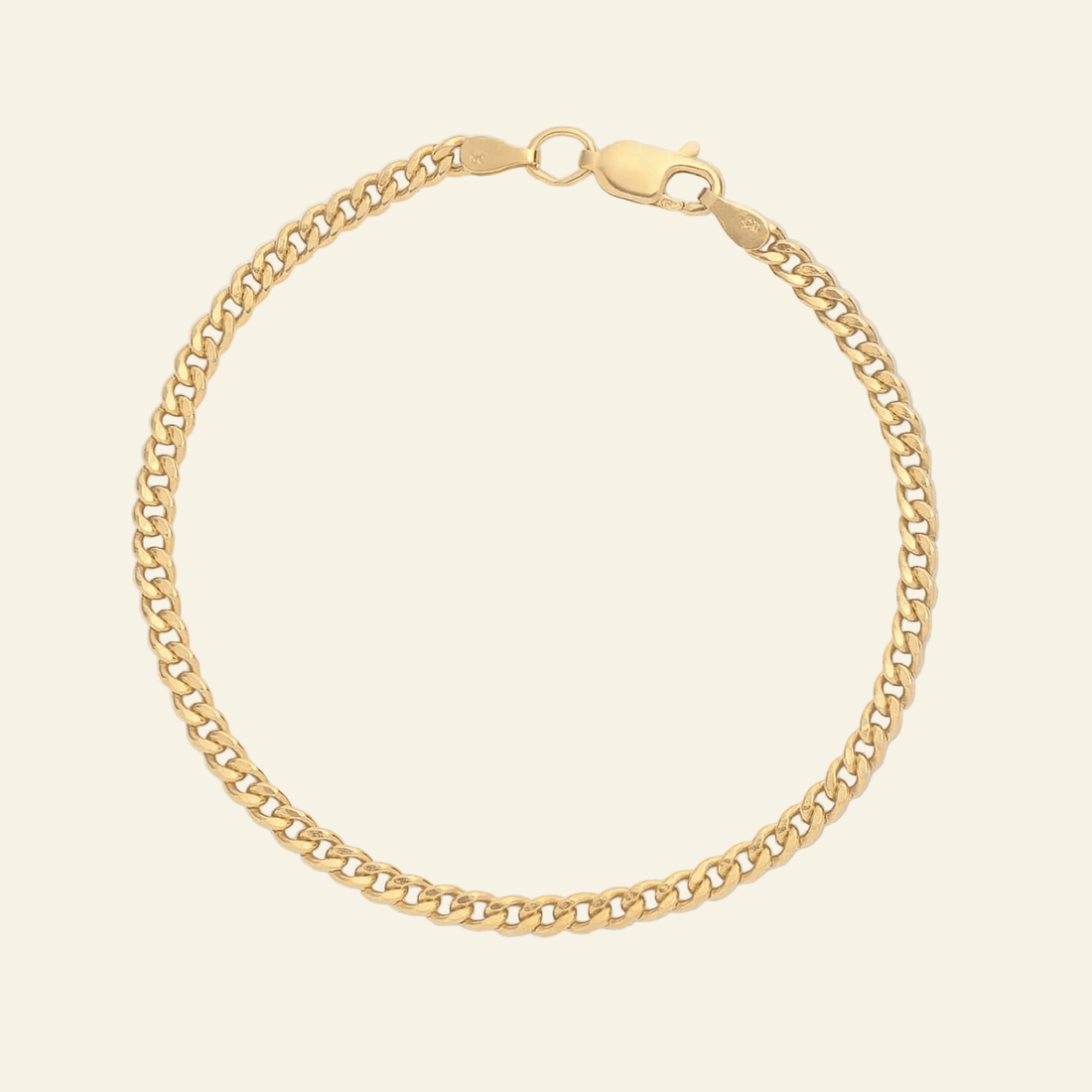 Gold chain bracelet on a light gray background