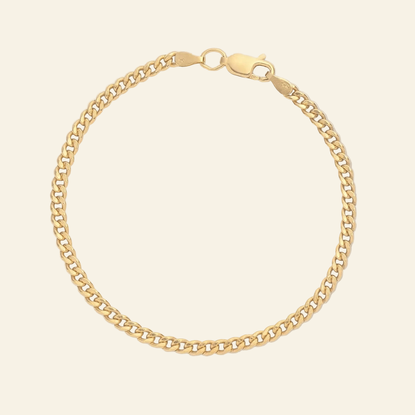 Gold chain bracelet on a light gray background
