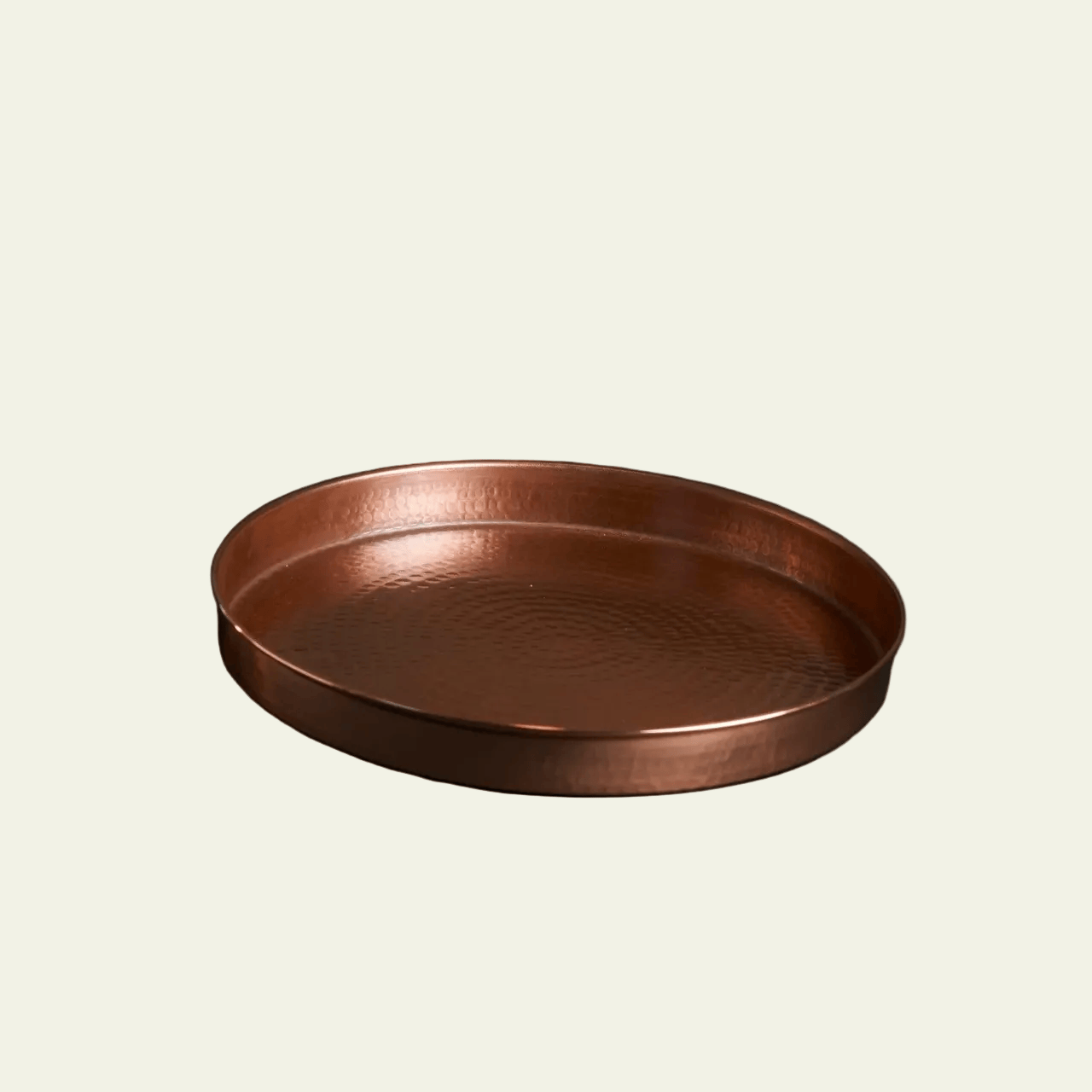 Copper tray on a beige background