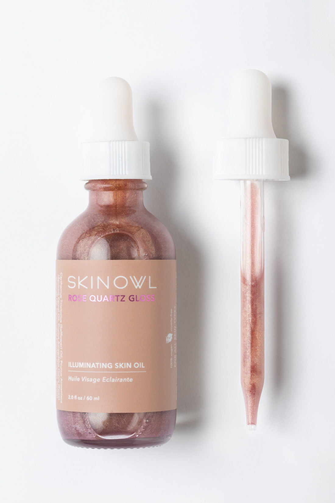 SKINOWL rose quartz glow oil bottle and dropper on a white background