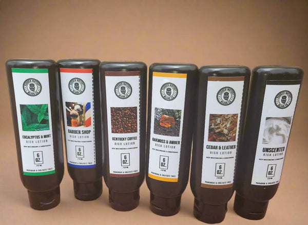 Set of six bottles of body wash with labels on a stone surface