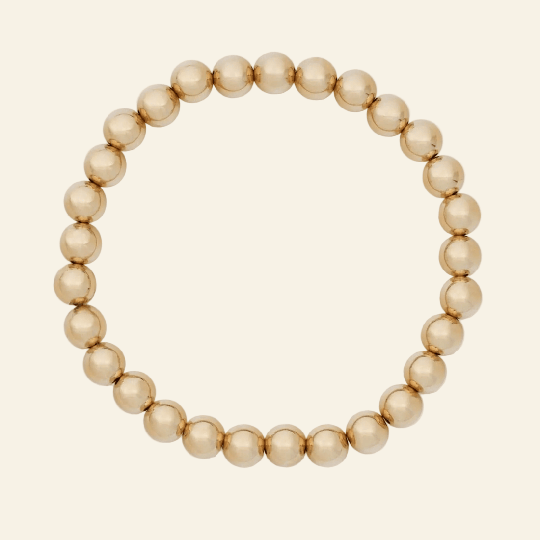 Gold beaded bracelet on a white background