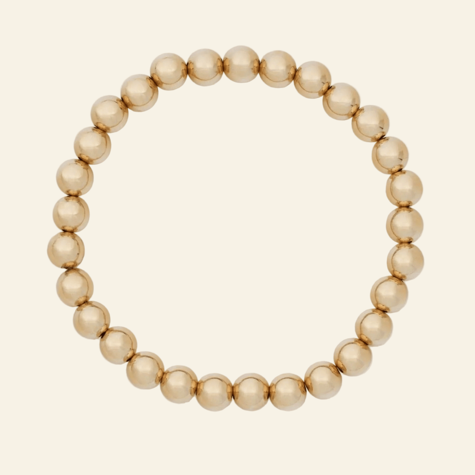 Gold beaded bracelet on a white background
