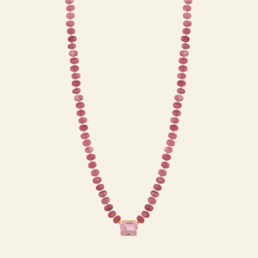 Necklace with pink beads and a pink pendant on a white background