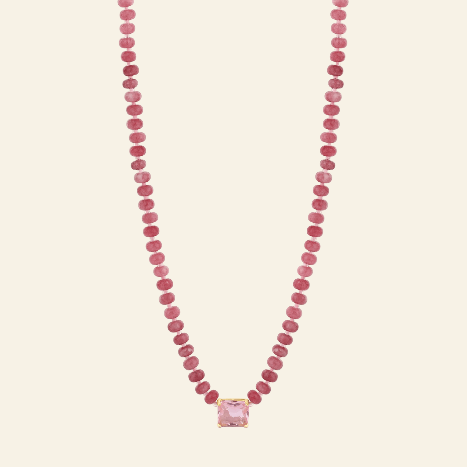 Necklace with pink beads and a pink pendant on a white background