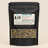 Tea package with label featuring herbal blend details against a blurred natural background