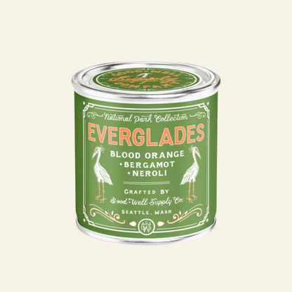 Green candle container labeled &