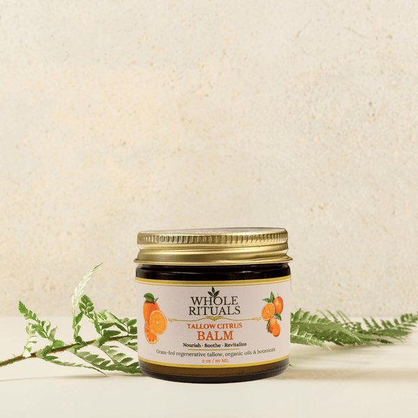 Jar of Whole Rituals balm with a gold lid on a textured beige background