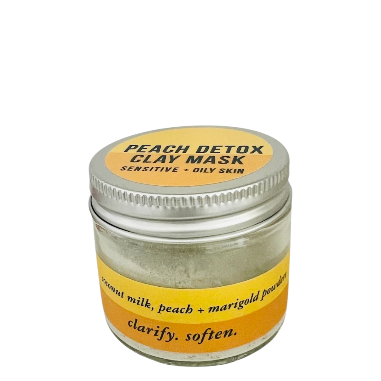 A small clear glass jar of peach detox clay mask with a silver metal lid and a yellow label, shown on a plain white background.
