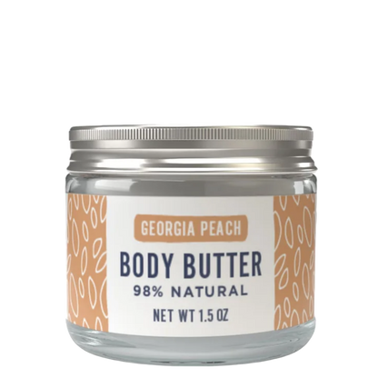 A 1.5 oz glass jar of Georgia Peach Body Butter with a silver metal lid and a white label featuring peach-colored patterns.