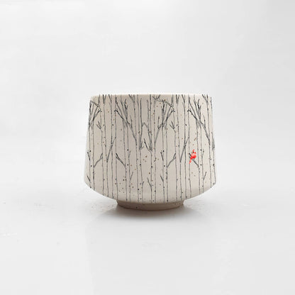 Ceramic pot with tree pattern on a white background