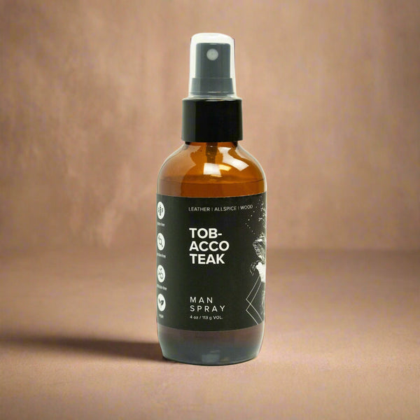 Bottle of Tobacco Teak man spray on a light beige background