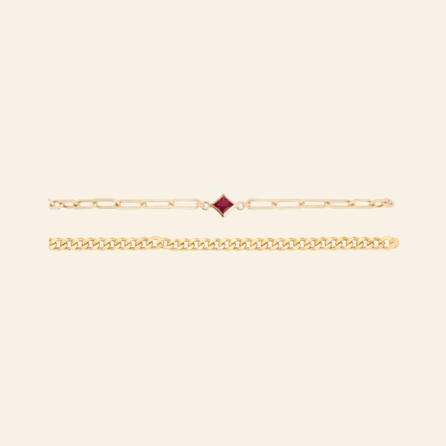 Gold bracelet with a red gemstone on a light gray background