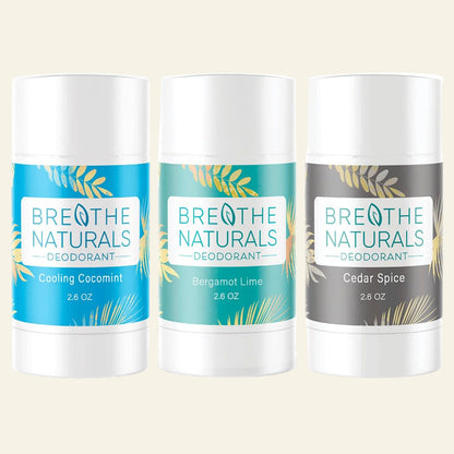 Three Breathe Naturals deodorant sticks with different scents on a white background