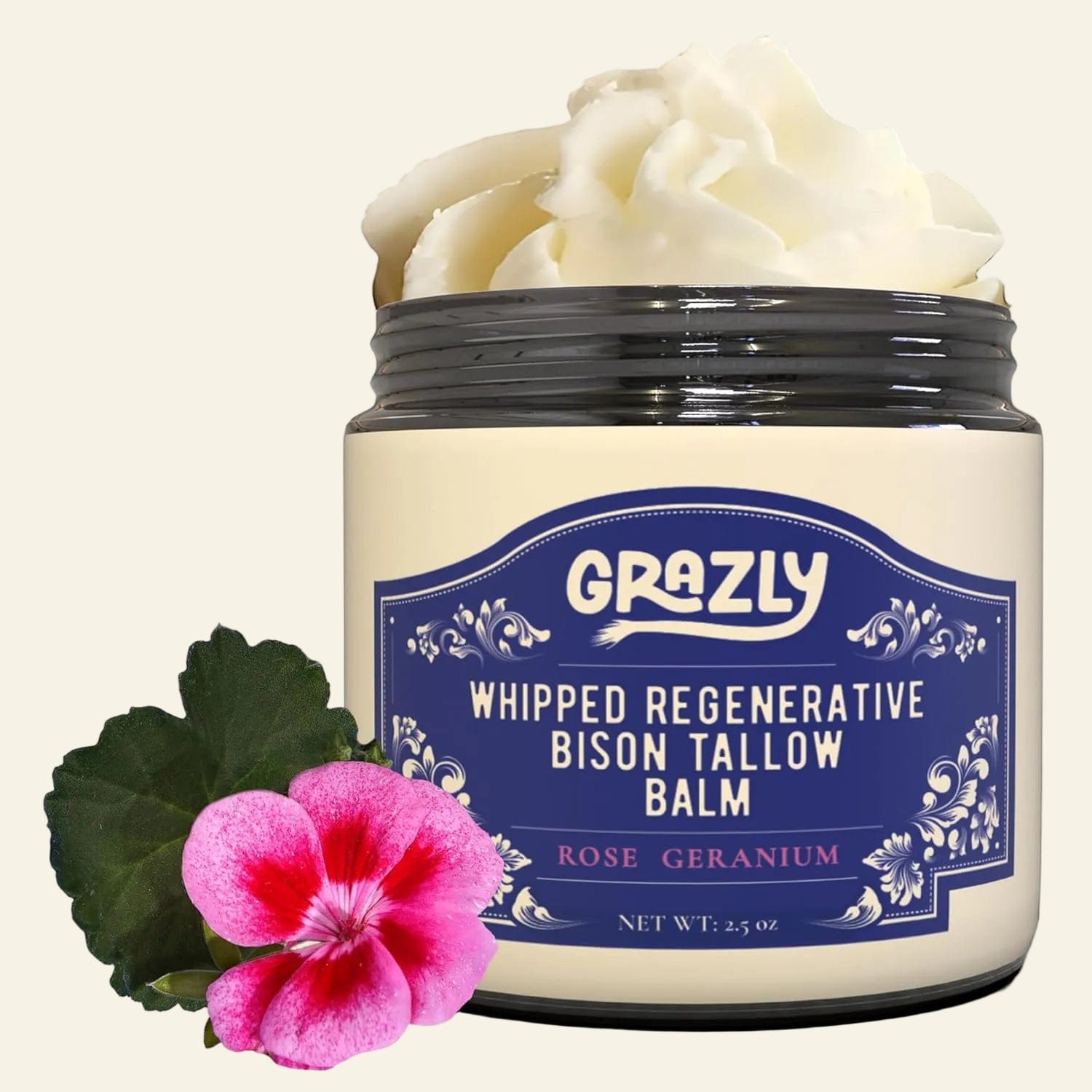 Jar of Grazly whipped regenerative bison tallow balm with a pink flower and green leaf on a white background