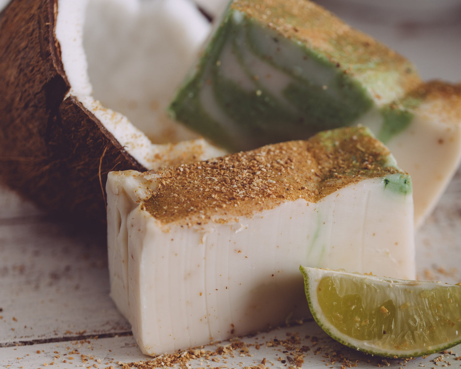 Coconut pieces with lime wedge on a wooden surface