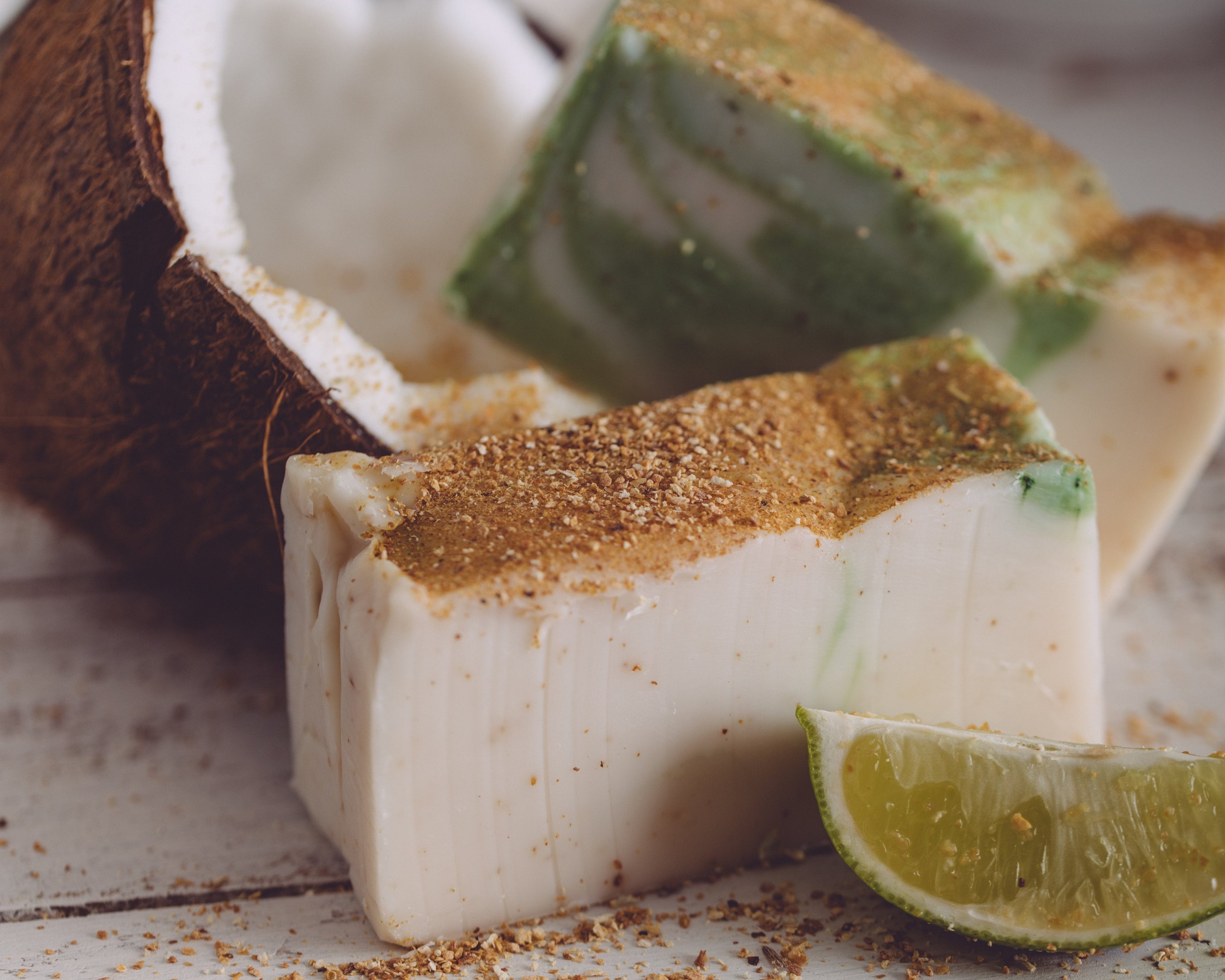 Coconut pieces with lime wedge on a wooden surface