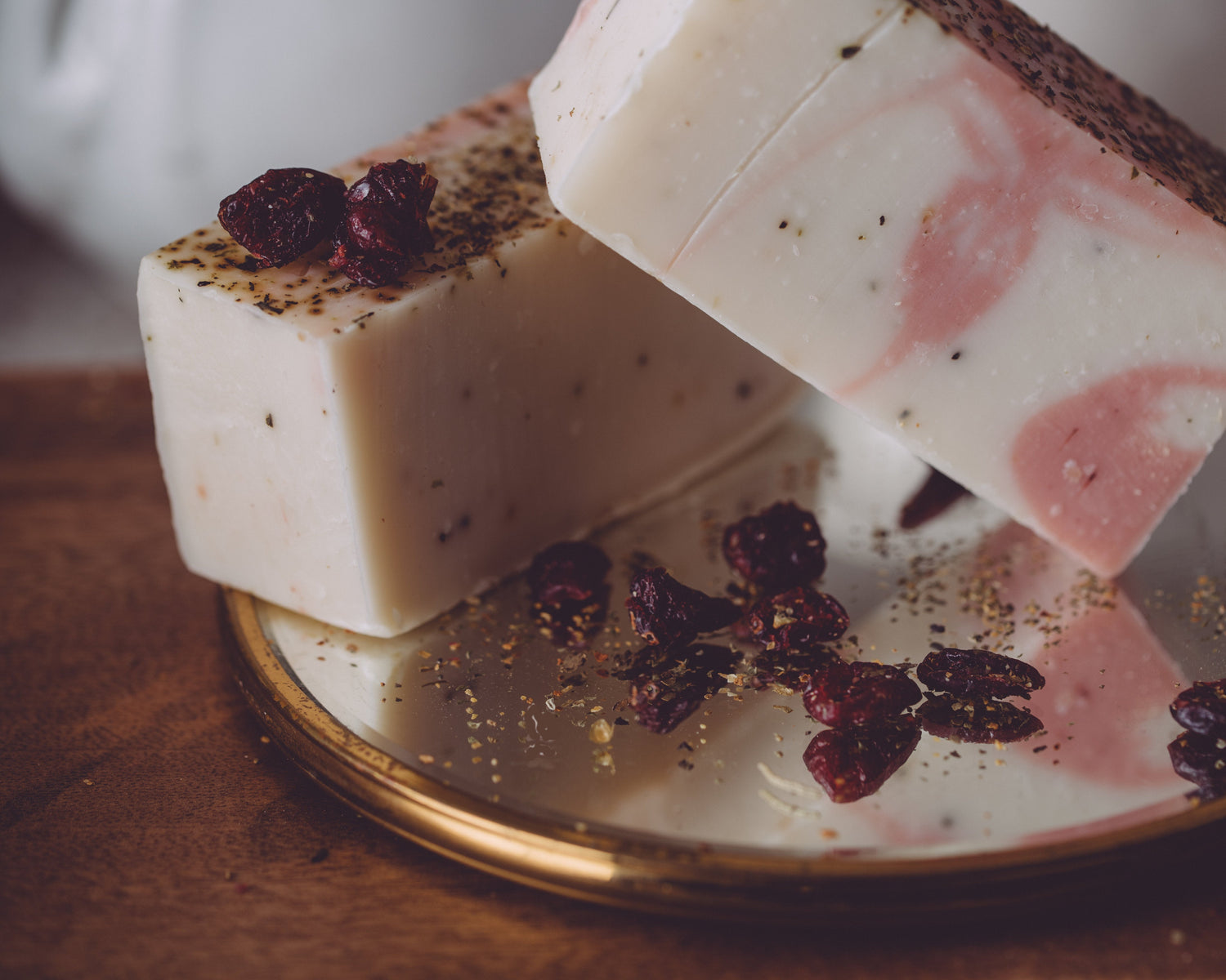 Two soap bars with decorative elements on a plate