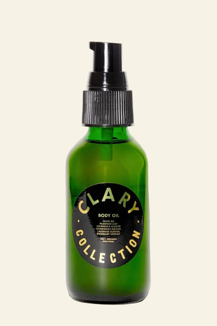 Green bottle of Clary Collection body oil with black pump on a white background